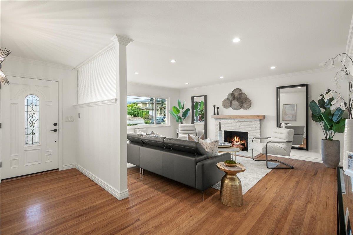 7669 Rainbow Drive Cupertino, CA 95014 - Photo 7 of 37 a living room with furniture a fireplace and a potted plant