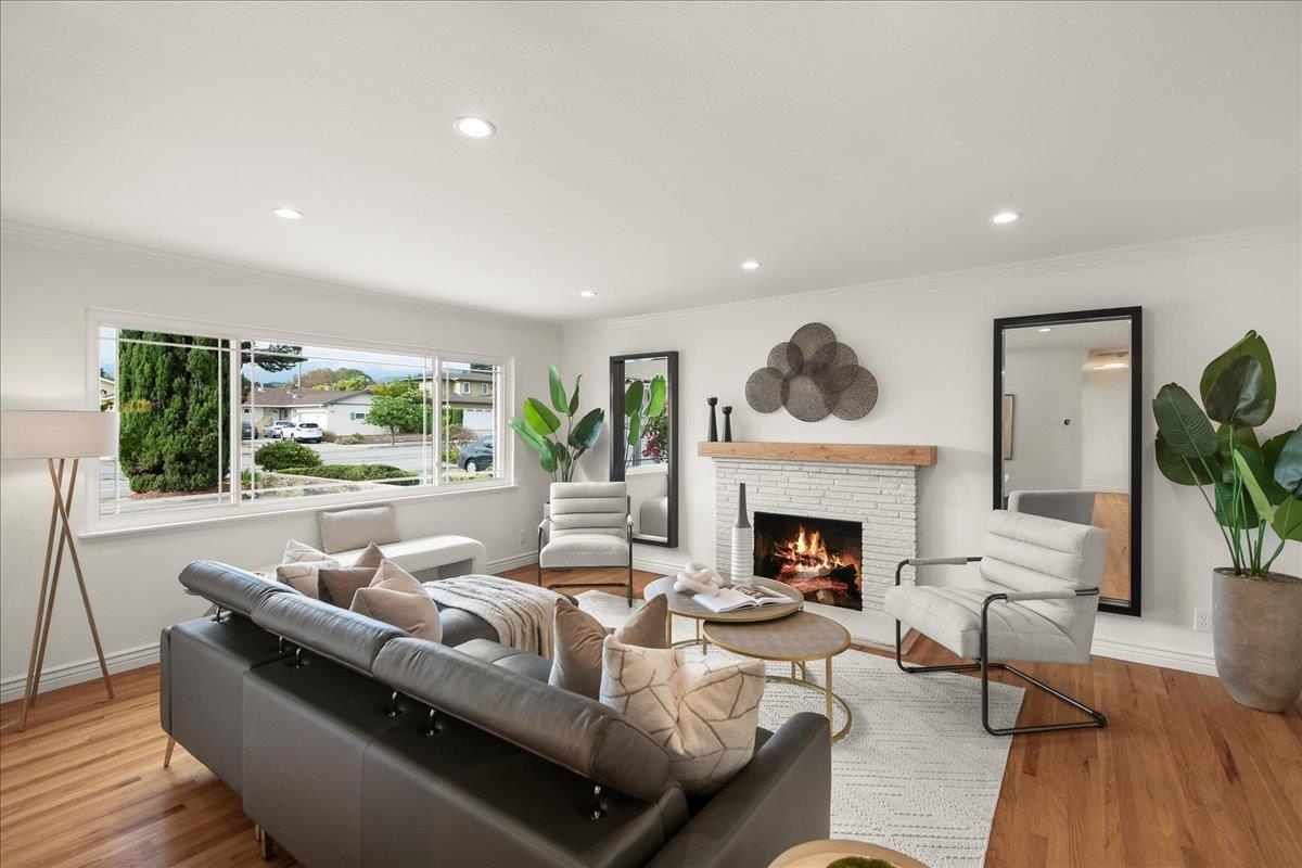 7669 Rainbow Drive Cupertino, CA 95014 - Photo 8 of 37 a living room with furniture fireplace and a large window