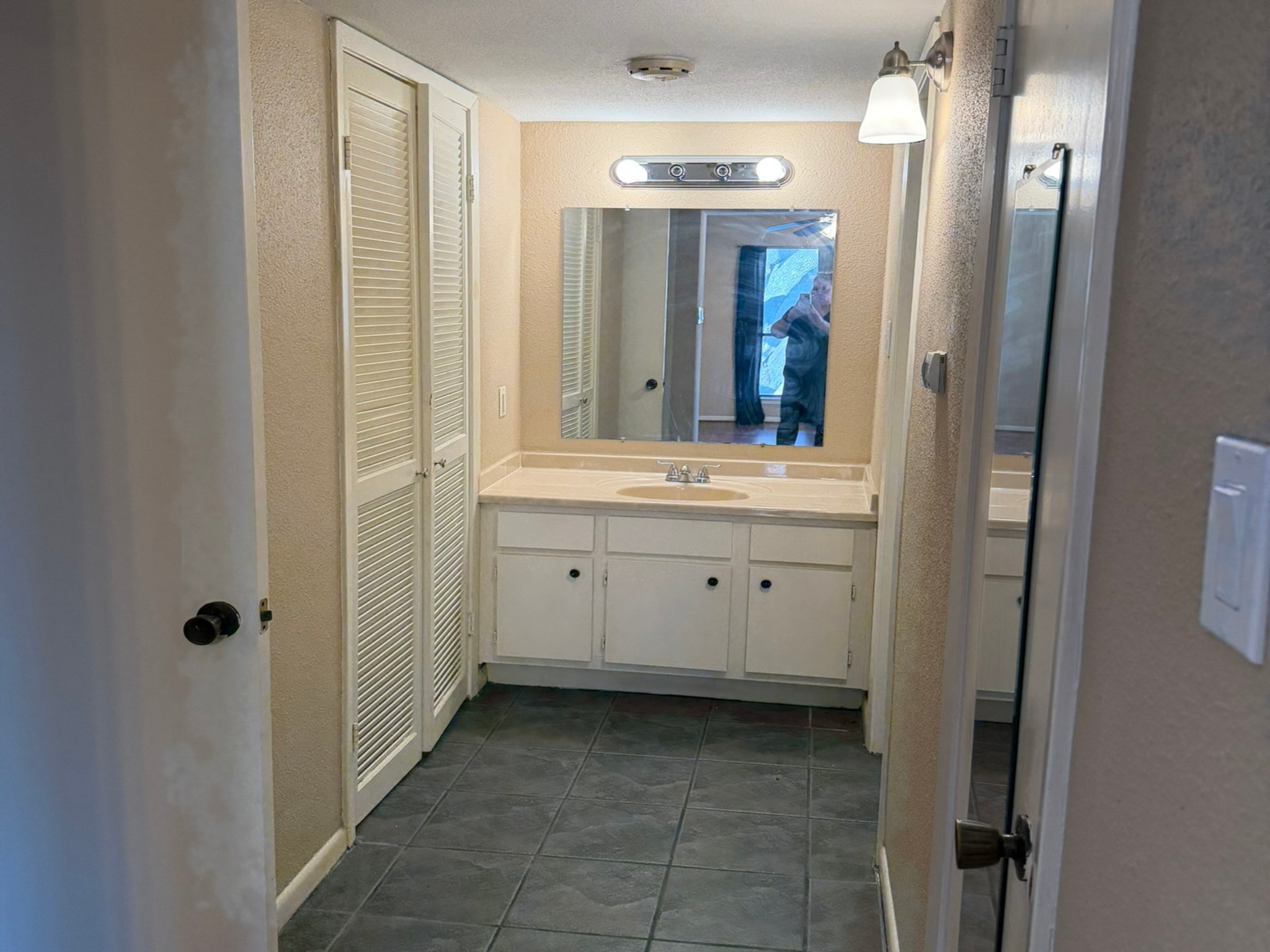 9000 Bissonnet Street, Unit 512 Houston, TX 77074 - Photo 8 of 13 a bathroom with a double vanity sink and mirror