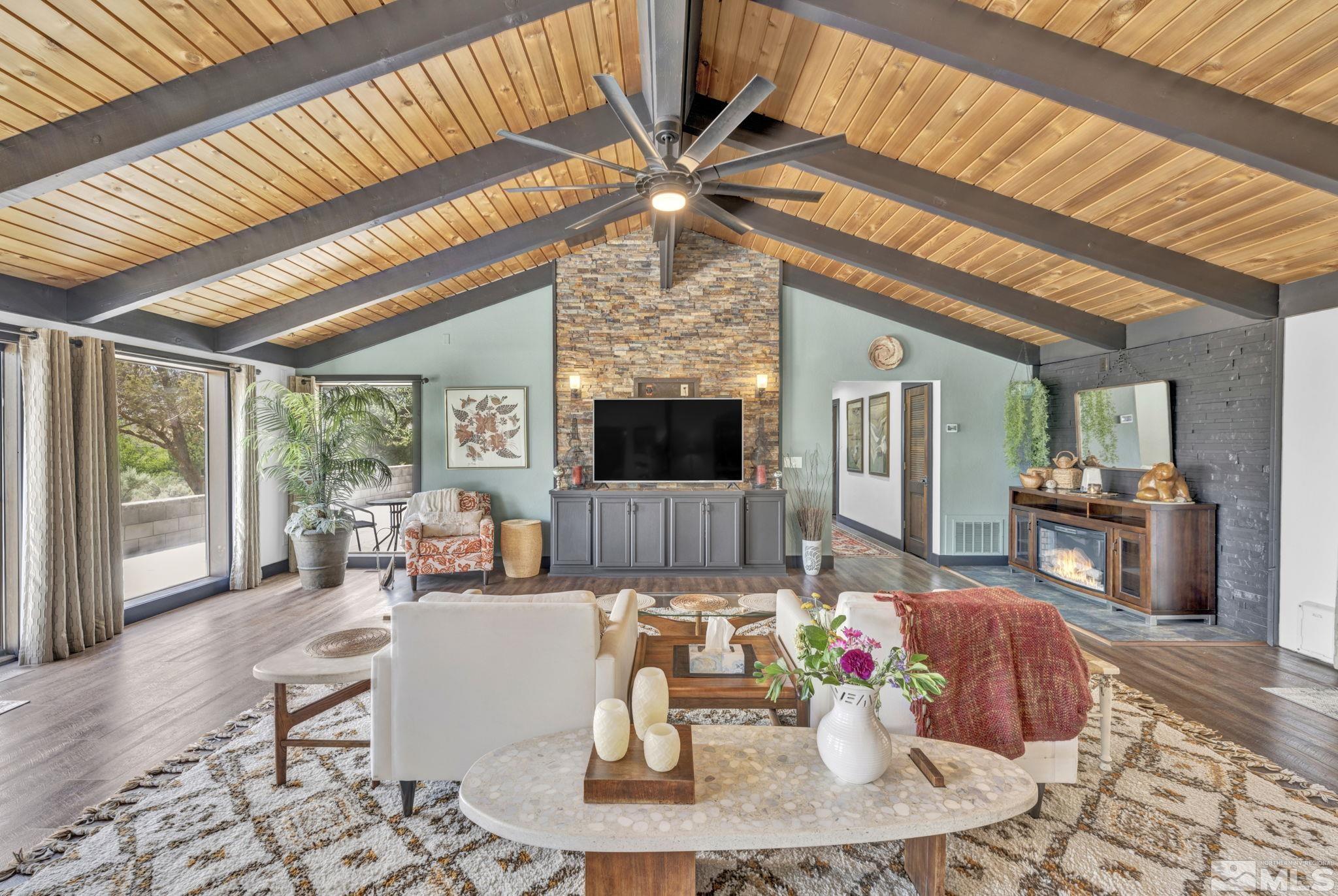 a living room with fireplace furniture and a flat screen tv
