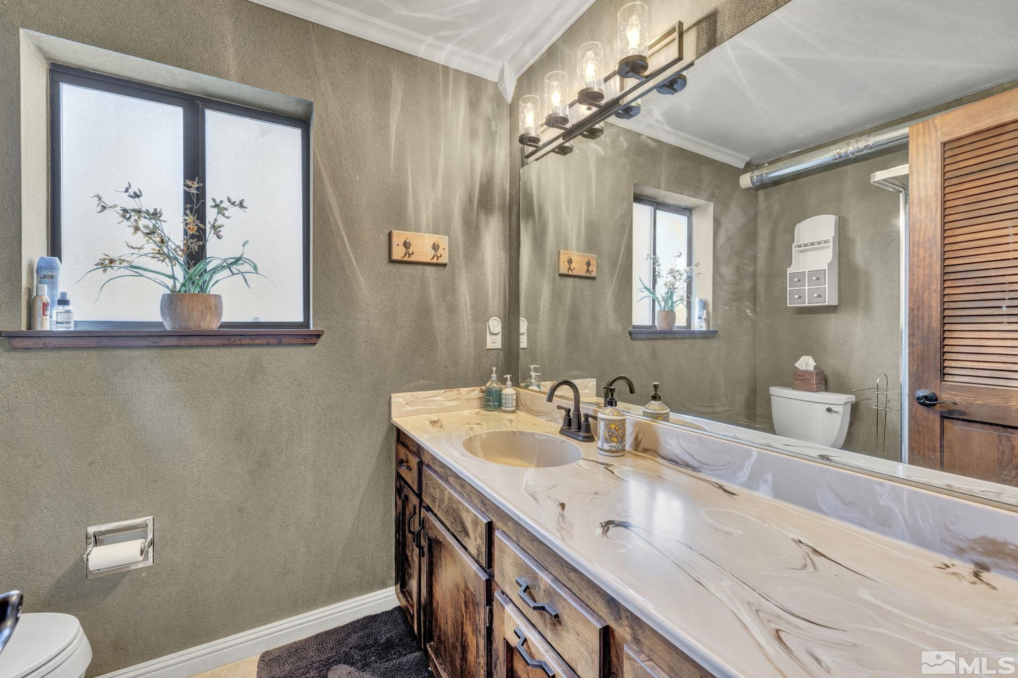 310 Ruby Lane Carson City, NV 89706 - Photo 17 of 40 a bathroom with a double vanity sink and a mirror