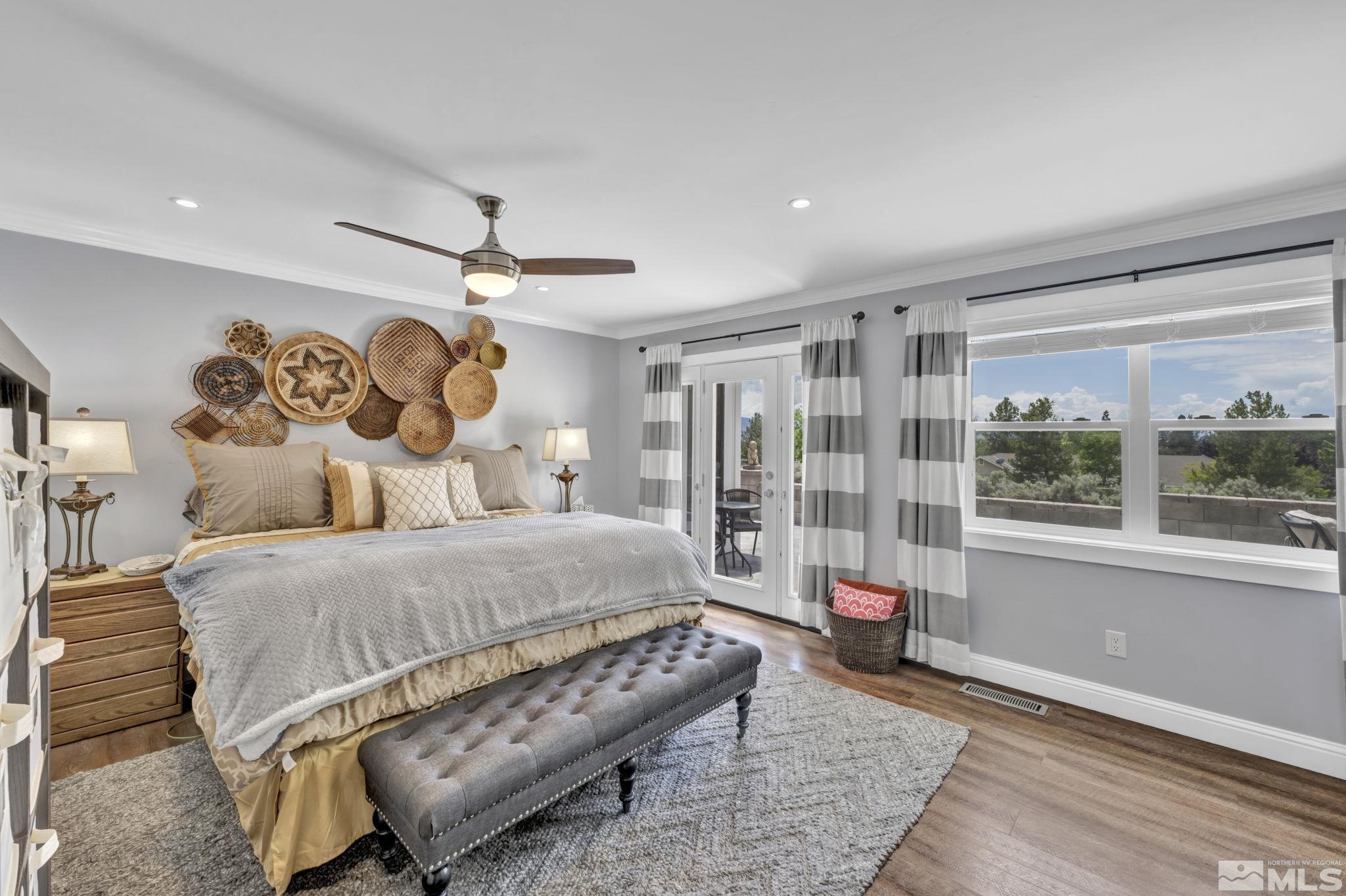 310 Ruby Lane Carson City, NV 89706 - Photo 18 of 40 a bedroom with a large bed and a chandelier