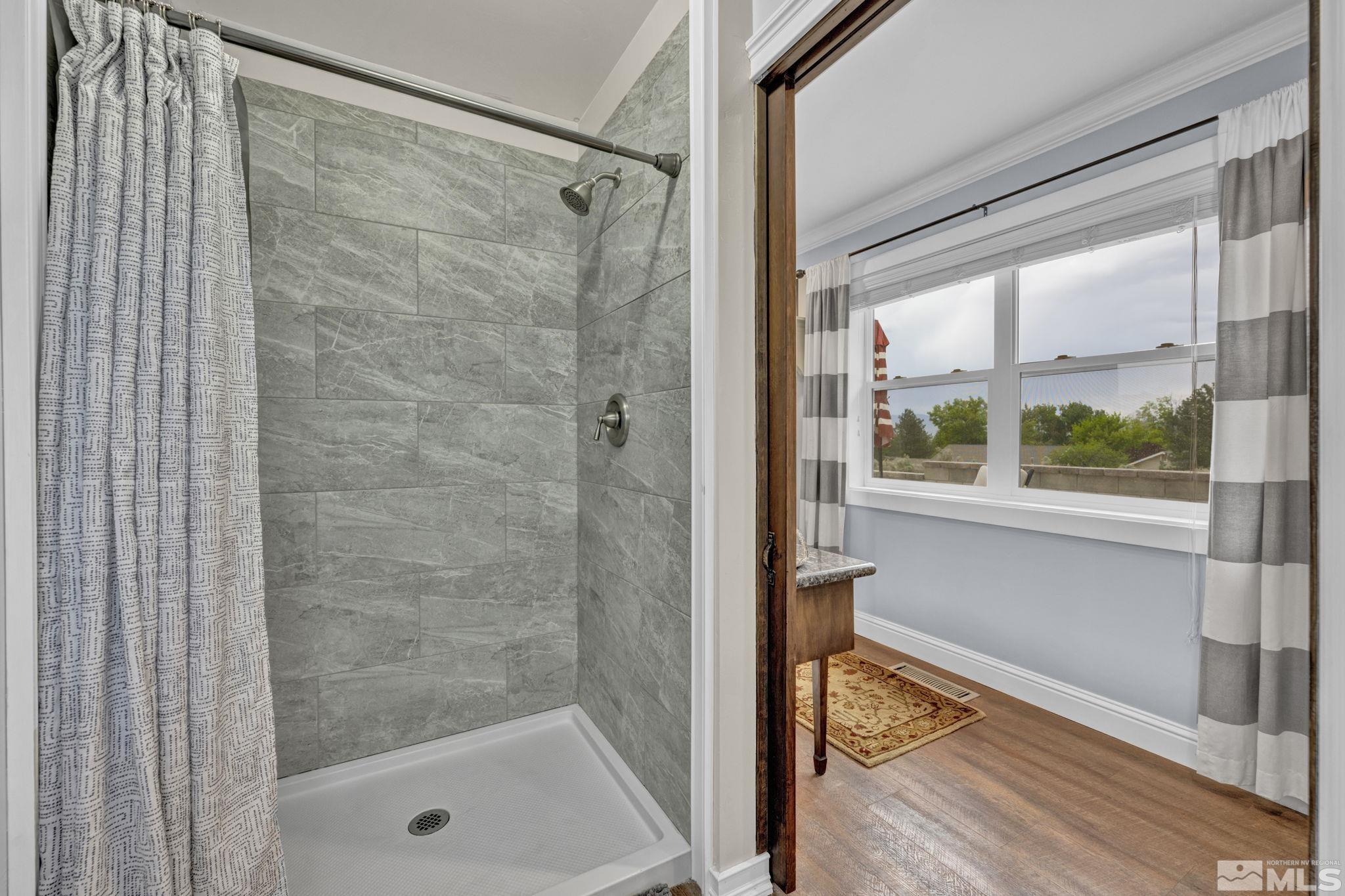 310 Ruby Lane Carson City, NV 89706 - Photo 22 of 40 a bathroom with a glass shower door