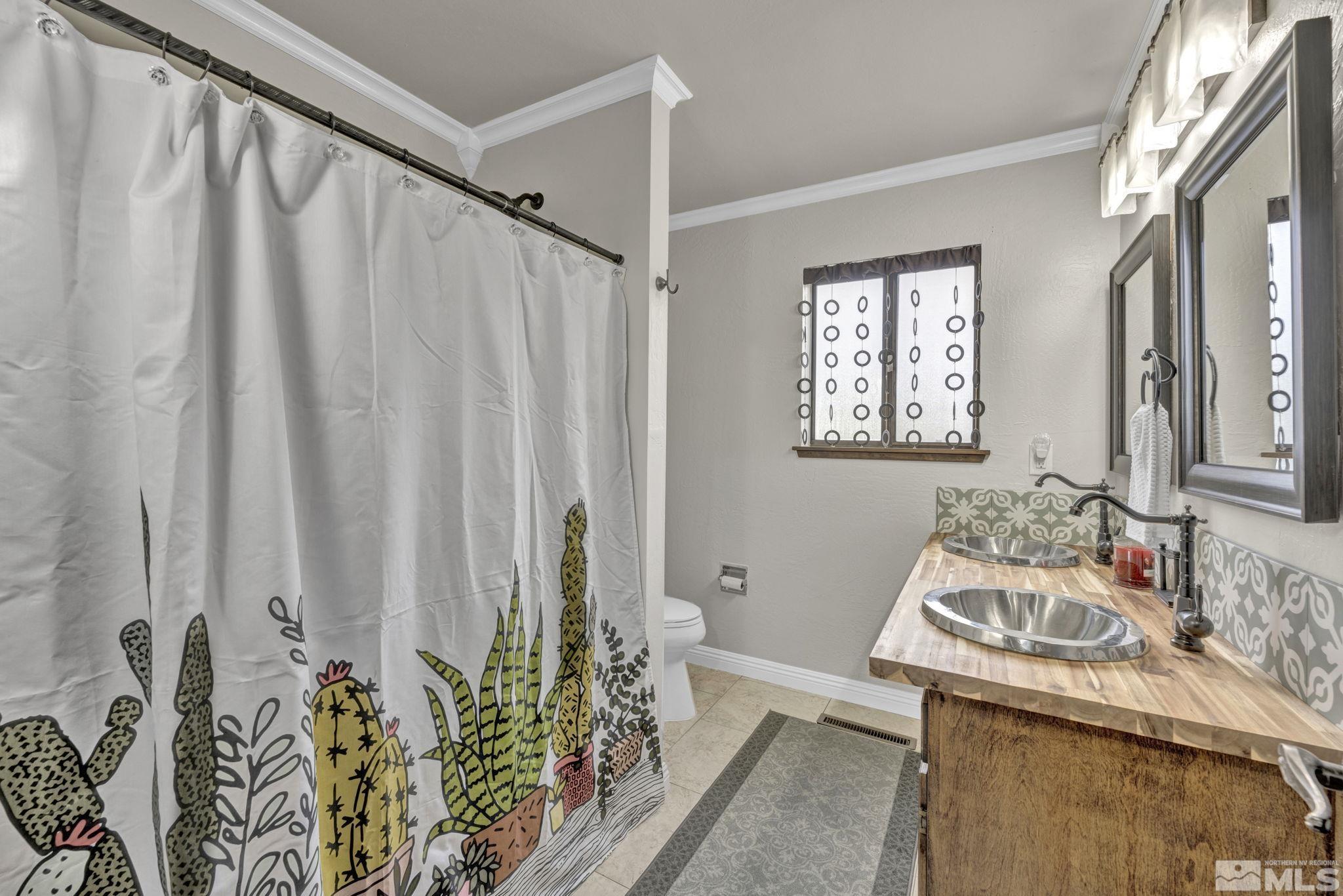 310 Ruby Lane Carson City, NV 89706 - Photo 23 of 40 a bedroom with a bed and a table