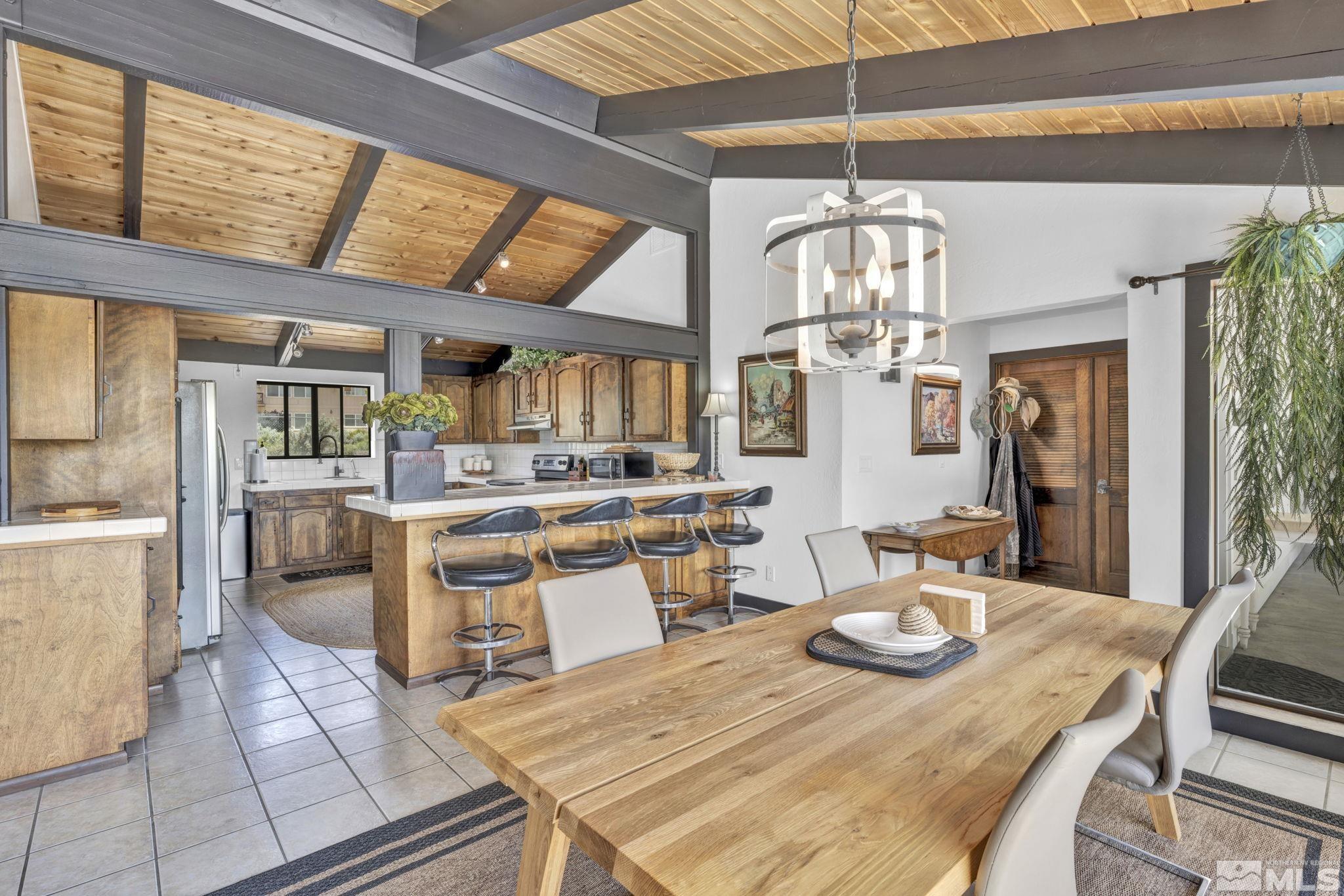 310 Ruby Lane Carson City, NV 89706 - Photo 8 of 40 a kitchen island with stainless steel appliances wooden floor dining table and chairs