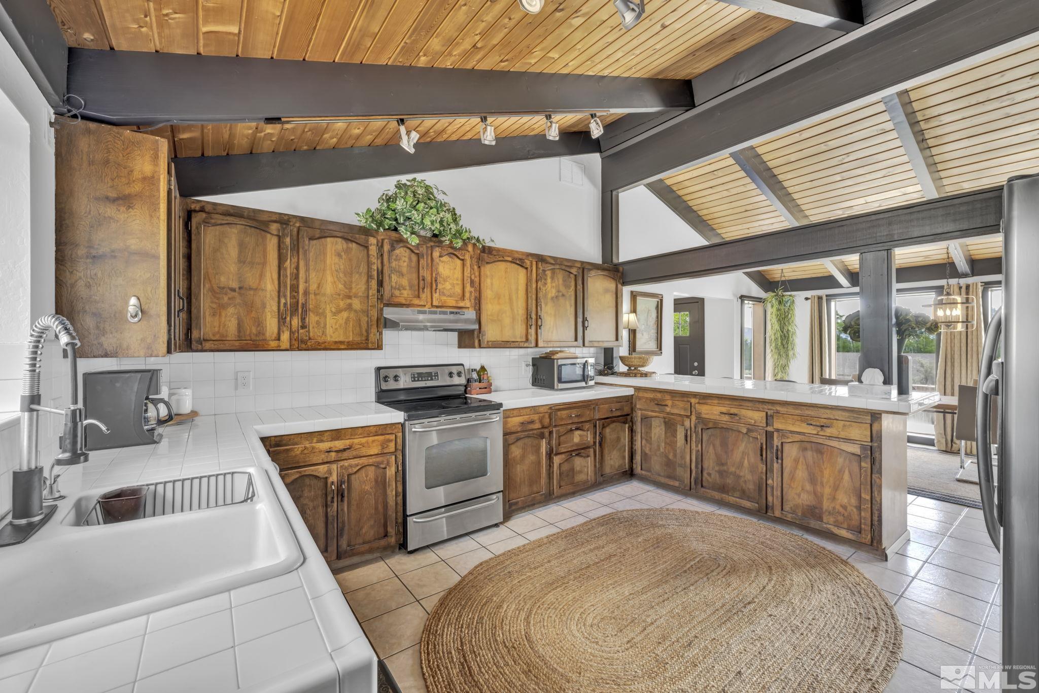 310 Ruby Lane Carson City, NV 89706 - Photo 9 of 40 a large kitchen with stainless steel appliances granite countertop a sink and cabinets