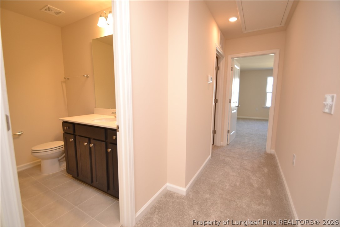 5703 Preveza Place Raleigh, NC 27603 - Photo 14 of 33 a view of a bathroom from the hallway