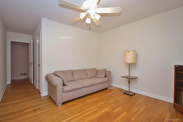 a living room with furniture a lamp and a rug