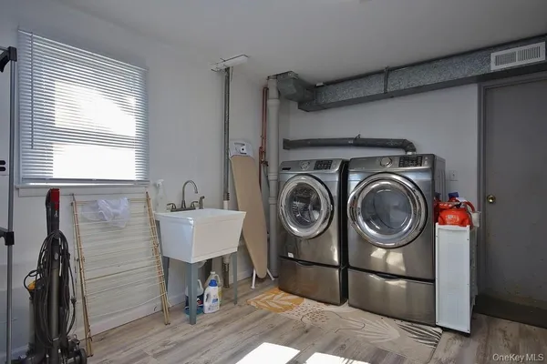 a view of a storage and utility room with washer and dryer
