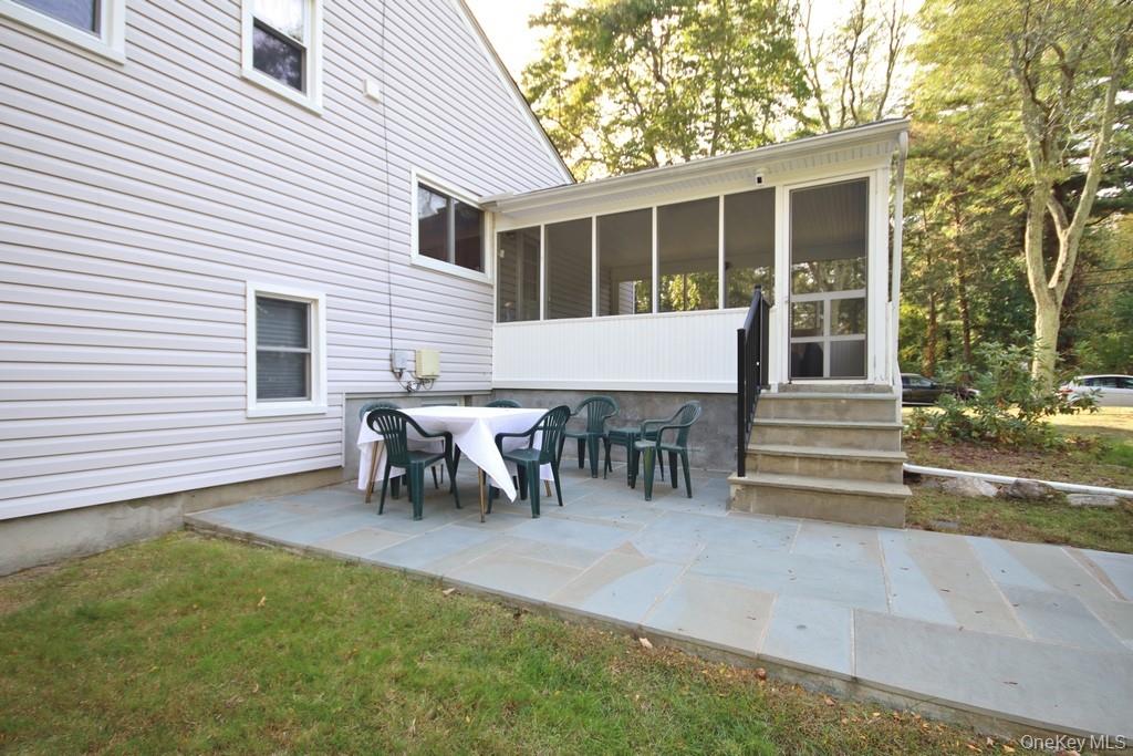 47 Fuller Road Briarcliff Manor, NY 10510 - Photo 30 of 34 a view of a house with a backyard and chairs