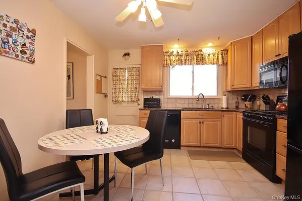 a kitchen with a sink a stove a table and chairs