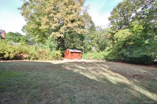 a backyard of a house with a yard and outdoor seating