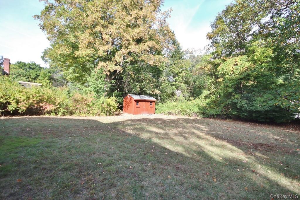 47 Fuller Road Briarcliff Manor, NY 10510 - Photo 32 of 34 a backyard of a house with a yard and outdoor seating