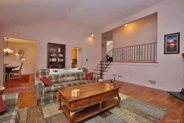 a living room with furniture a rug and a window