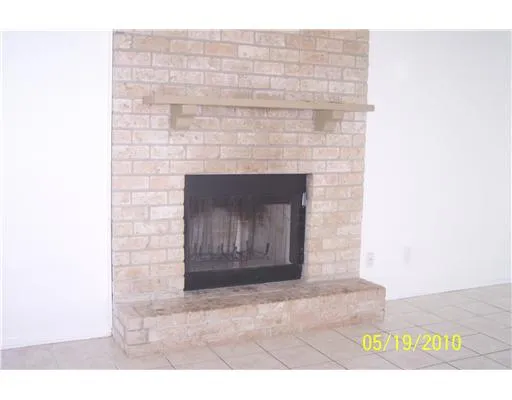 a stone fireplace with a bench