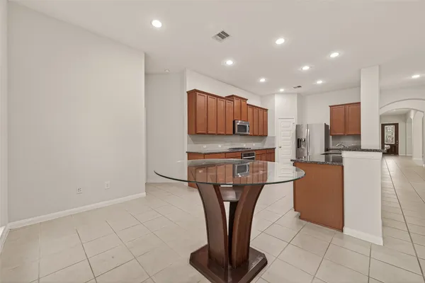 a kitchen with stainless steel appliances granite countertop a refrigerator sink and cabinets