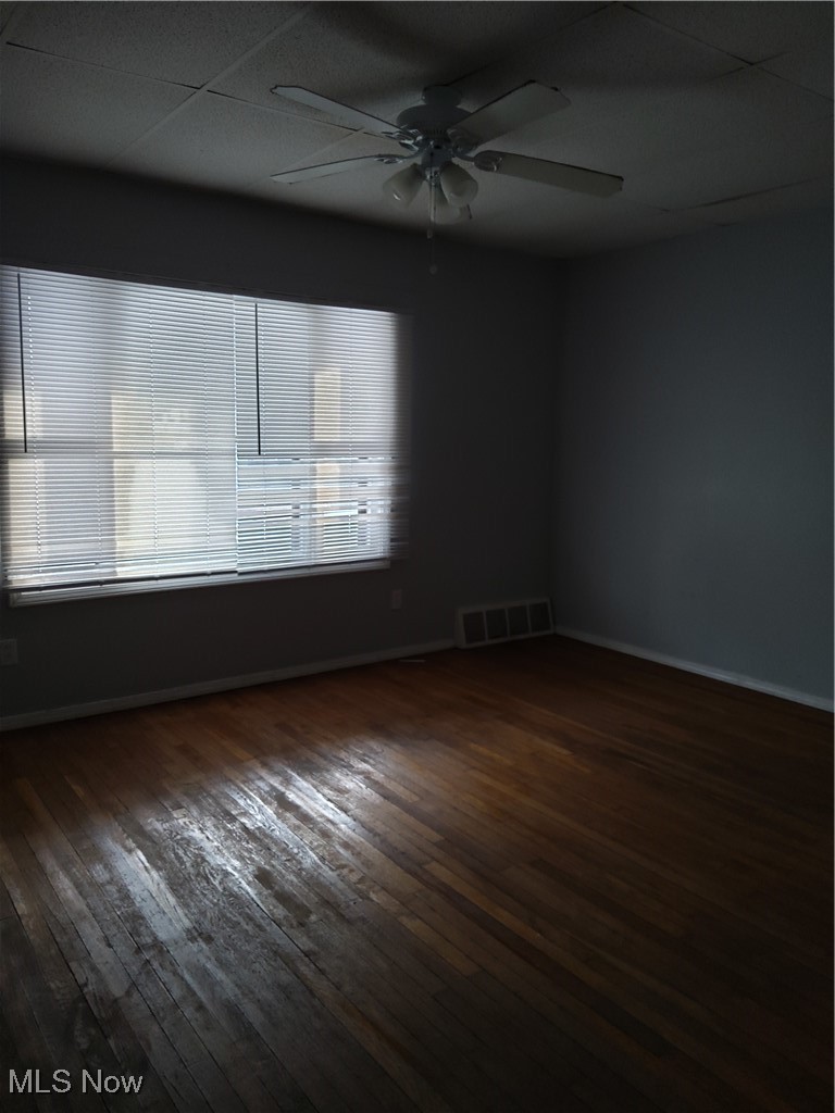 7117 Ottawa Road Cleveland, OH 44105 - Photo 6 of 25 Unfurnished room with ceiling fan, a healthy amount of sunlight, and dark hardwood / wood-style floors