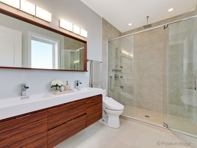 1430 West Fillmore Street, Unit 3W Chicago, IL 60607 - Photo 10 of 17 a bathroom with a sink a toilet and shower