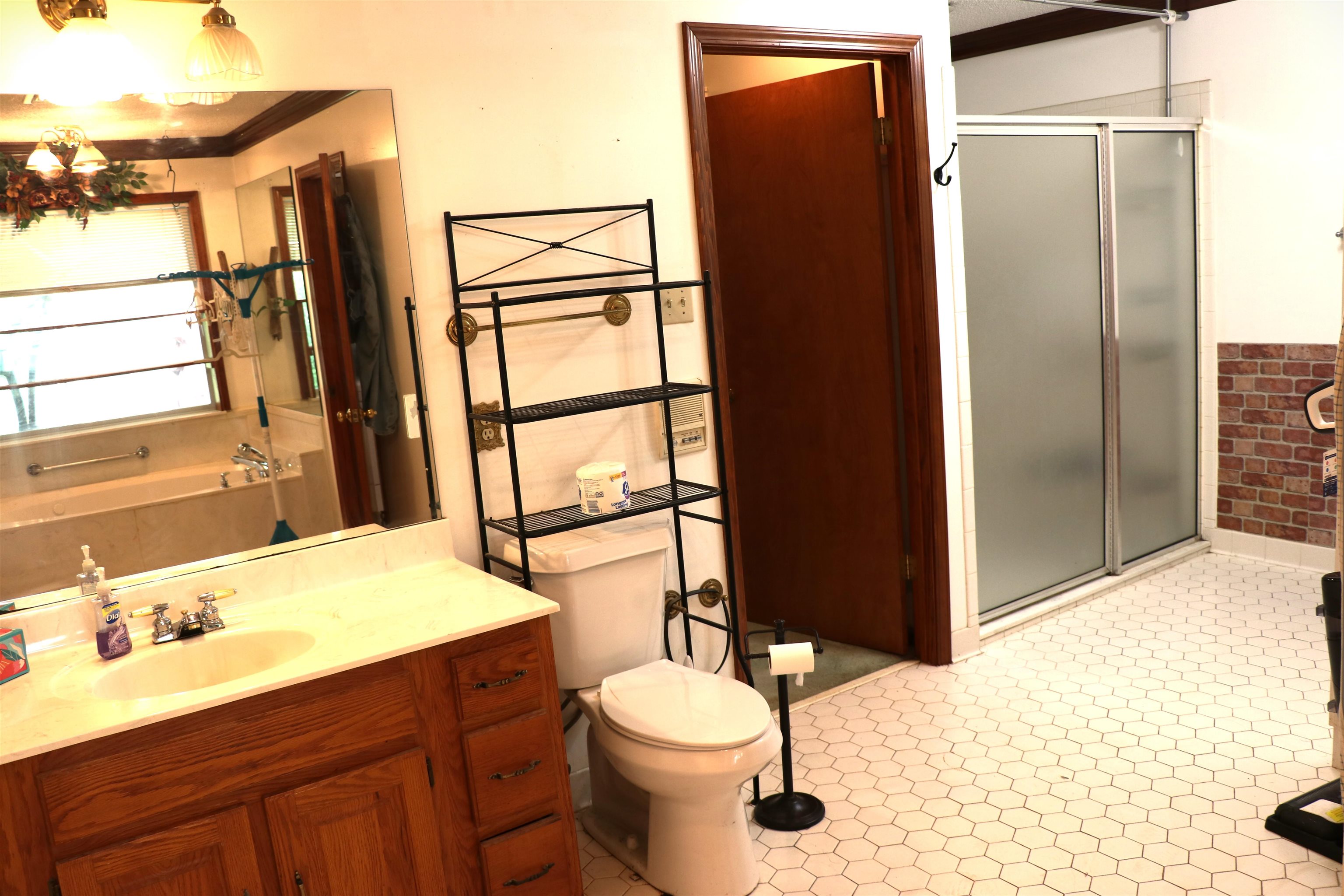 937 Kelleys Chapel Road Burlison, TN 38015 - Photo 14 of 40 Bathroom featuring a wood-finish vanity with an integrated sink and light-toned countertop, a full-width mirror, and overhead lighting