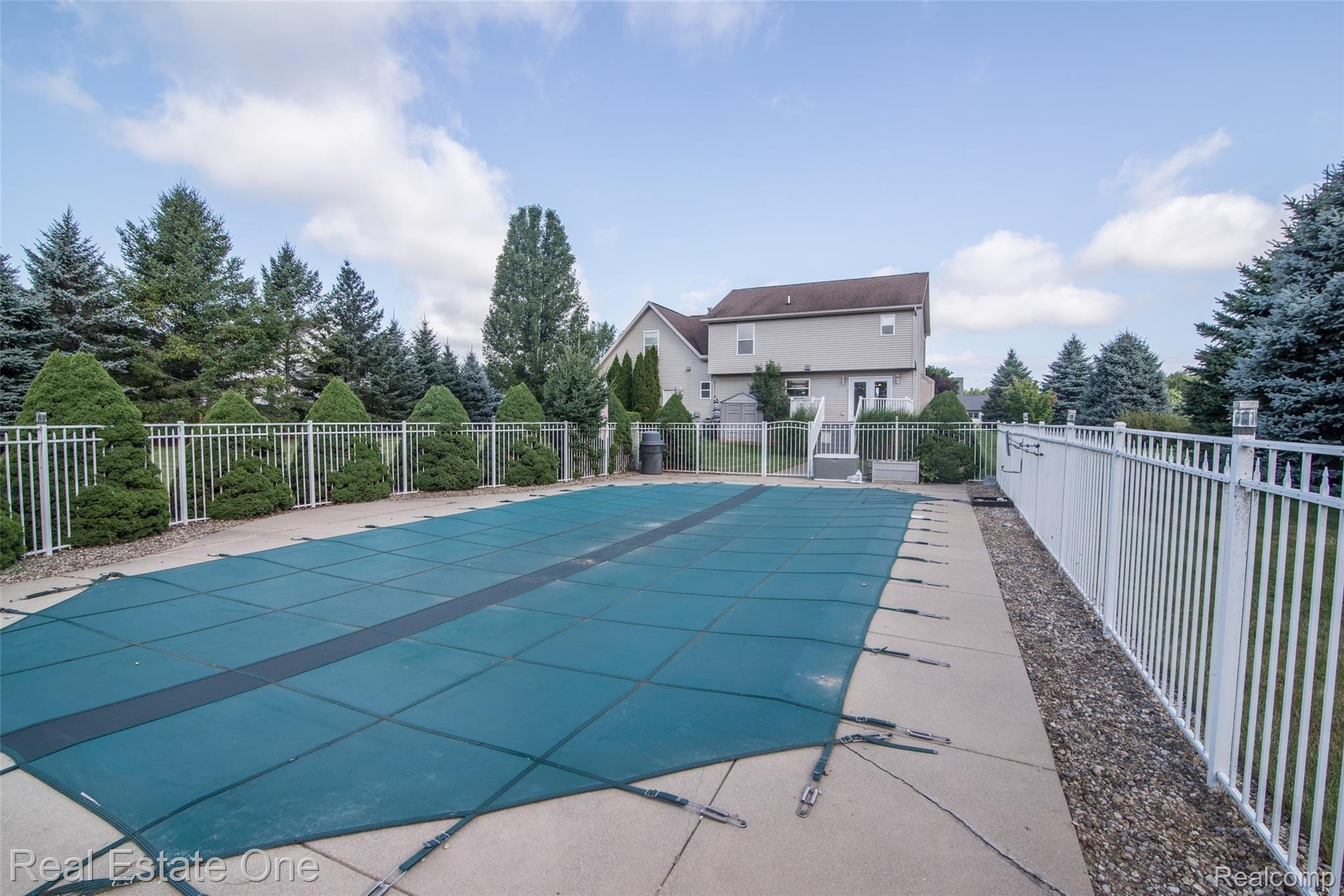 2631 Clivedon Road Howell, MI 48843 - Photo 8 of 32 fenced in ground pool.