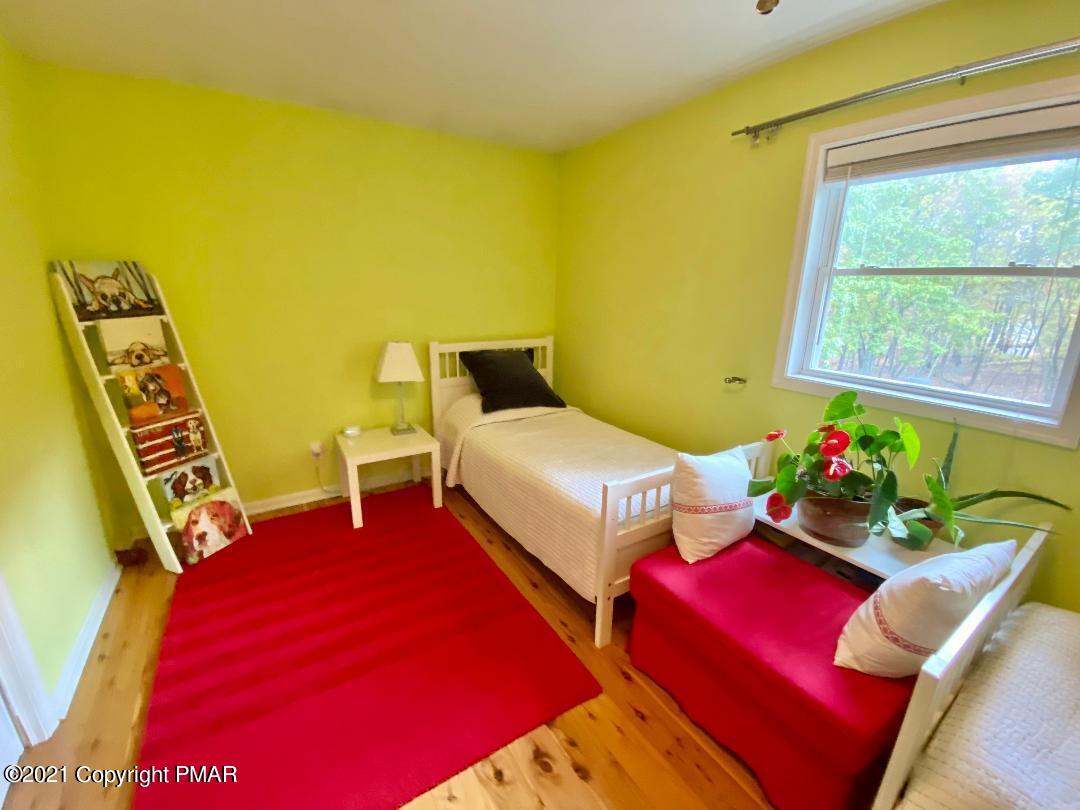 3196 Bobcat Drive Bushkill, PA 18324 - Photo 11 of 24 a bedroom with three beds and a table