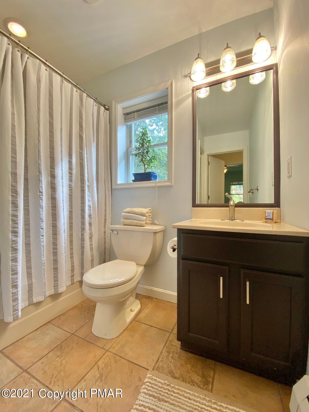 3196 Bobcat Drive Bushkill, PA 18324 - Photo 14 of 24 a bathroom with a sink vanity mirror and toilet