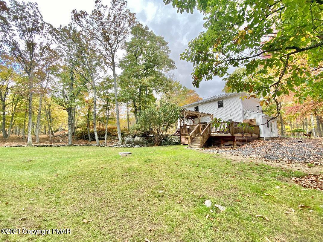 3196 Bobcat Drive Bushkill, PA 18324 - Photo 16 of 24 a view of a backyard with large trees