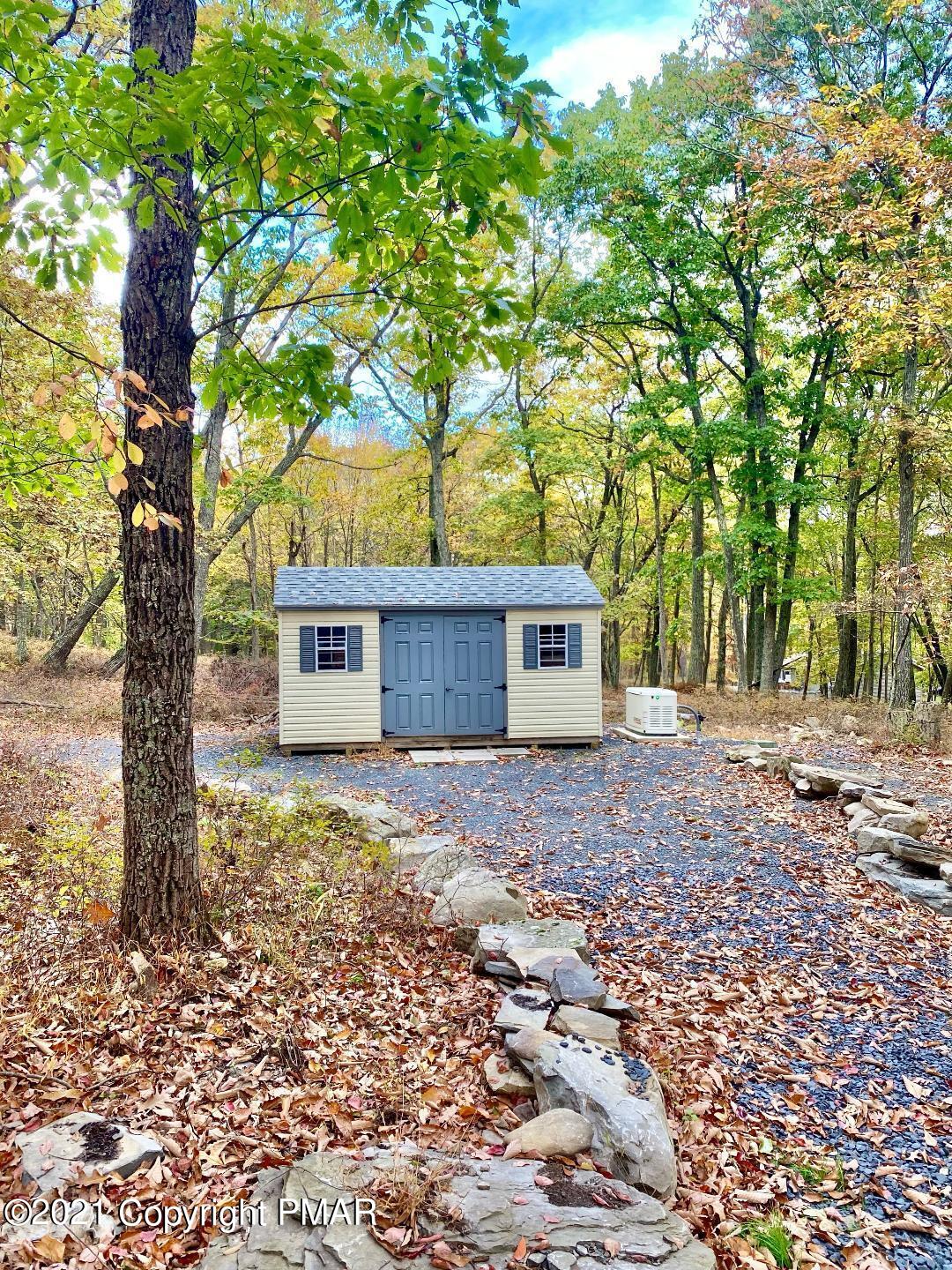 3196 Bobcat Drive Bushkill, PA 18324 - Photo 21 of 24 a large tree in front of a white house