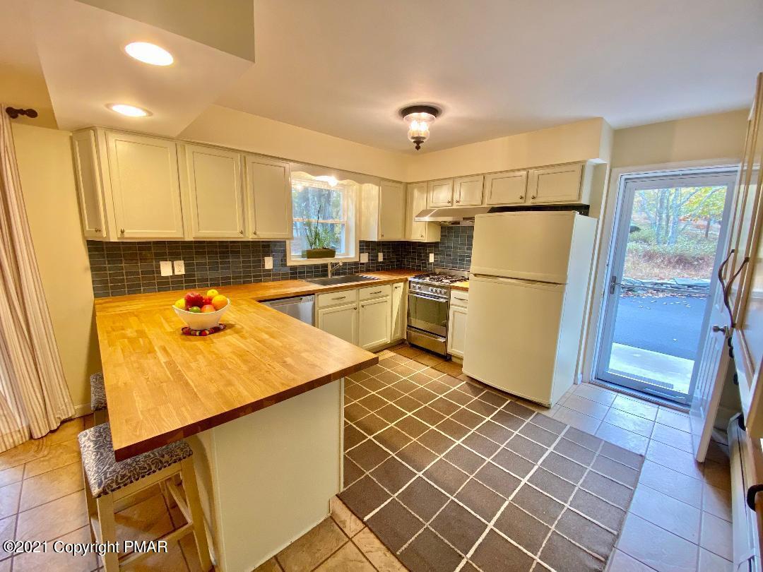 3196 Bobcat Drive Bushkill, PA 18324 - Photo 4 of 24 a kitchen with a sink a refrigerator and a stove top oven