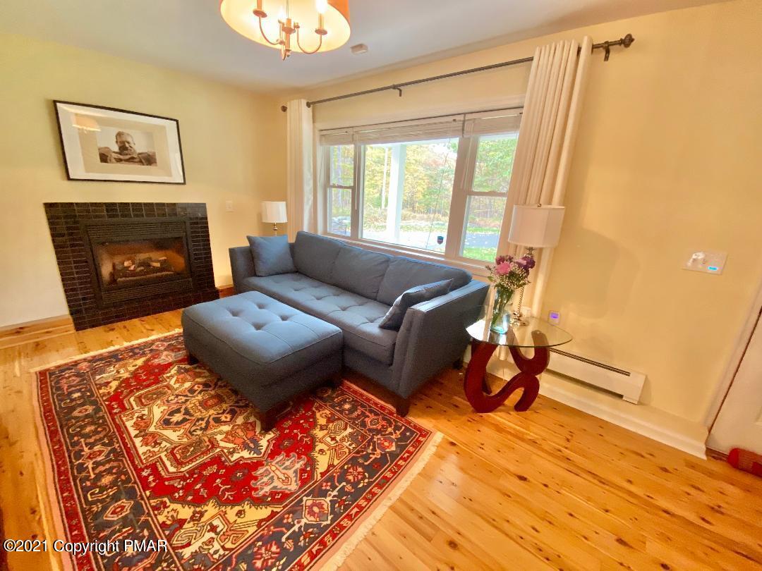 3196 Bobcat Drive Bushkill, PA 18324 - Photo 6 of 24 a living room with furniture and a fireplace