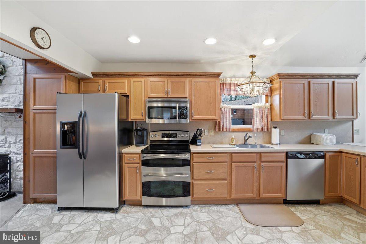 15 Hazard Run Road Lake Harmony, PA 18624 - Photo 22 of 46 a kitchen with stainless steel appliances a sink a stove a refrigerator cabinets and a window