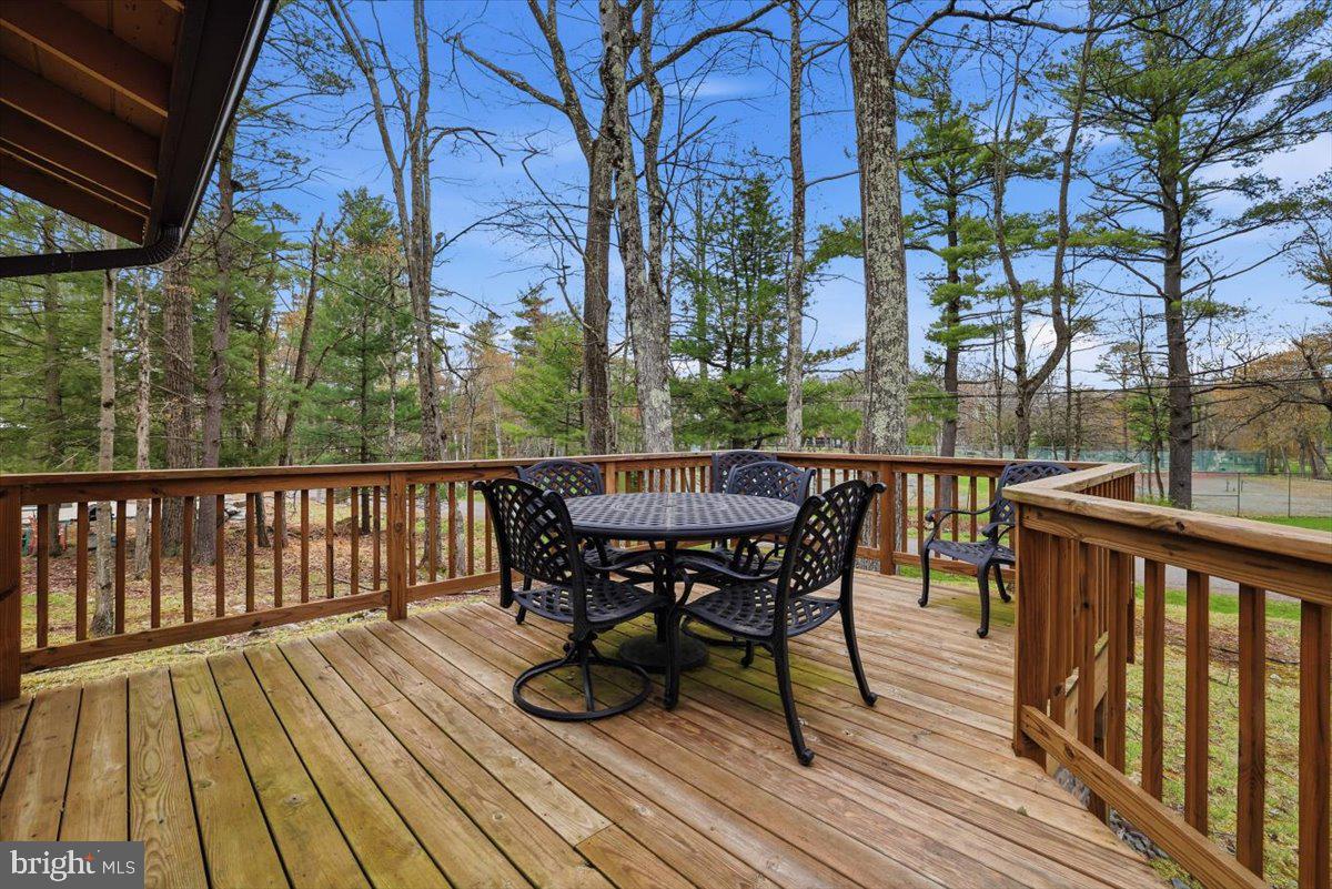 15 Hazard Run Road Lake Harmony, PA 18624 - Photo 6 of 46 a view of a deck with table and chairs and wooden floor