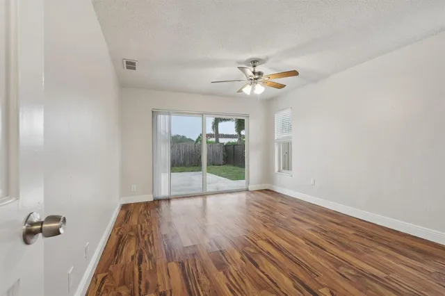wooden floor in an empty room with a window