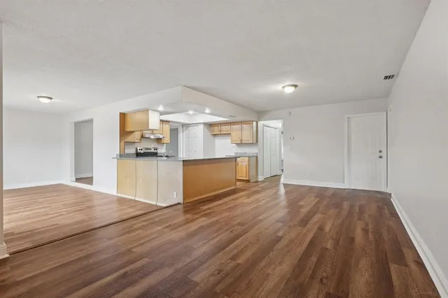 a kitchen with stainless steel appliances granite countertop a sink refrigerator and cabinets