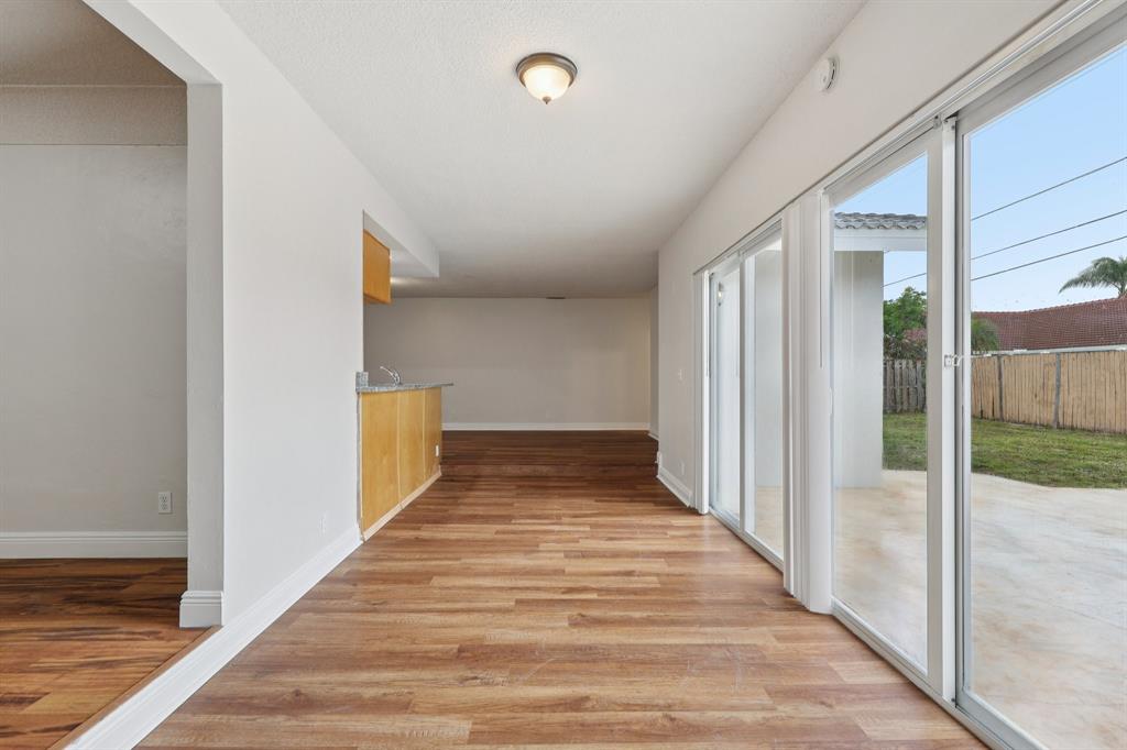 1541 Northwest 9th Street Boca Raton, FL 33486 - Photo 22 of 63 a view of a hallway with wooden floor and staircase