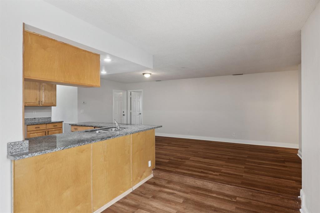 1541 Northwest 9th Street Boca Raton, FL 33486 - Photo 25 of 63 a view of a kitchen with kitchen island a sink wooden floor and a counter top space