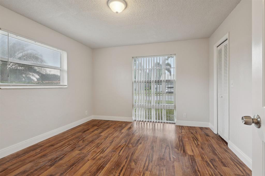 1541 Northwest 9th Street Boca Raton, FL 33486 - Photo 32 of 63 an empty room with wooden floor and windows