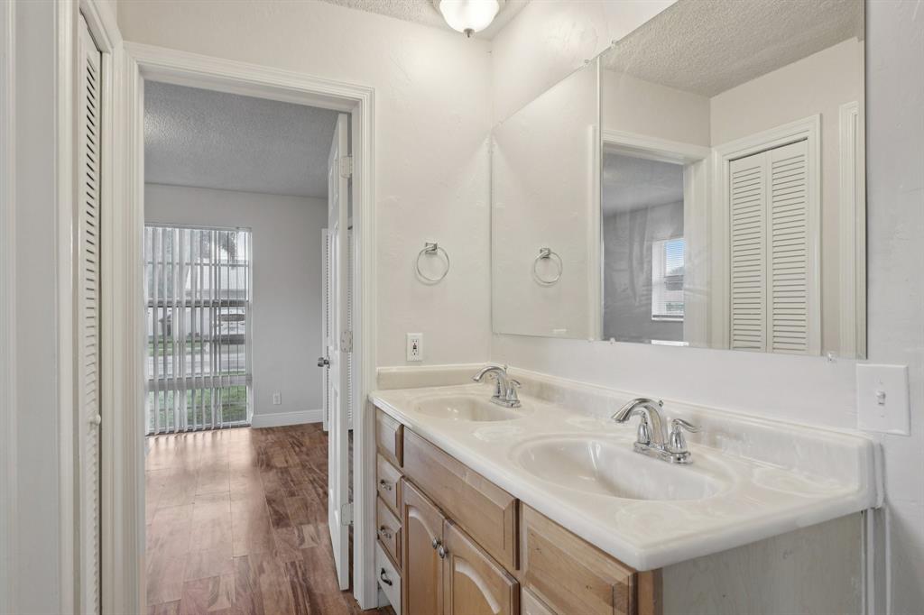 1541 Northwest 9th Street Boca Raton, FL 33486 - Photo 37 of 63 a bathroom with a sink and a mirror
