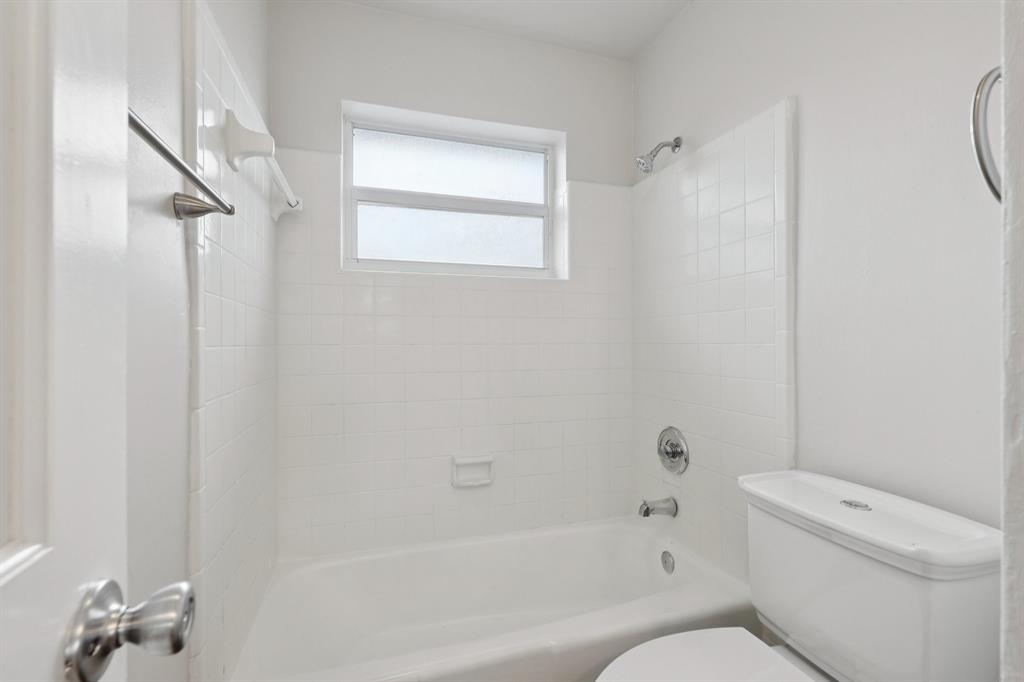 1541 Northwest 9th Street Boca Raton, FL 33486 - Photo 39 of 63 a bathroom with a toilet and a bathtub