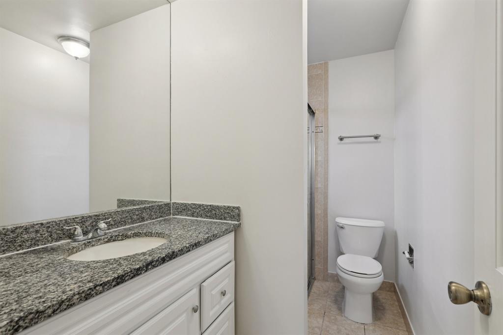 1541 Northwest 9th Street Boca Raton, FL 33486 - Photo 48 of 63 a bathroom with a granite countertop sink and a toilet
