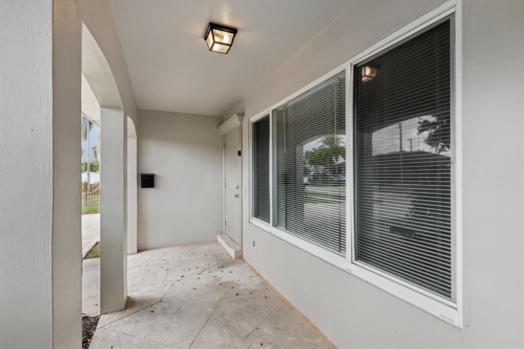 1541 Northwest 9th Street Boca Raton, FL 33486 - Photo 6 of 63 a view of a hallway with a glass door and shower