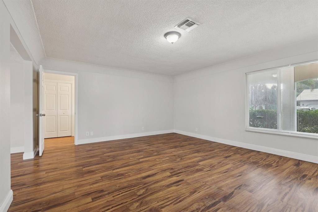 1541 Northwest 9th Street Boca Raton, FL 33486 - Photo 8 of 63 a view of an empty room with wooden floor and a window