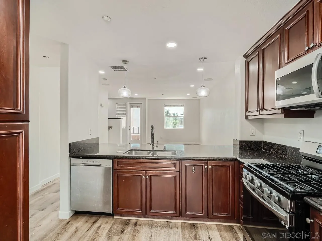10225 Daybreak Lane, Unit 5 Santee, CA 92071 - Photo 11 of 27 a kitchen with granite countertop a sink cabinets and stainless steel appliances