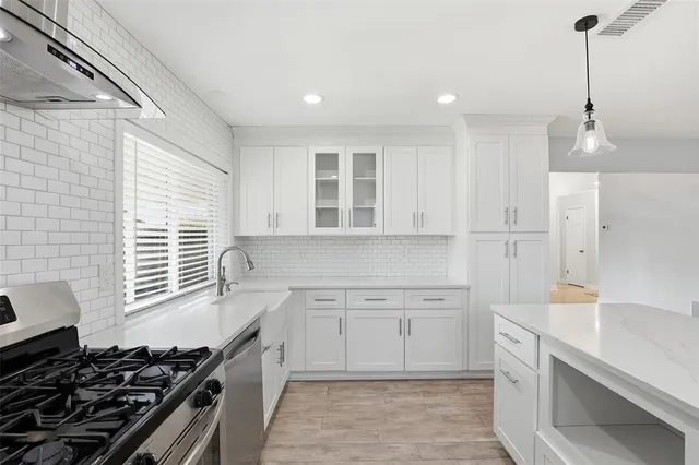 a kitchen that has a sink and a stove