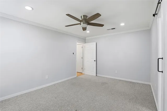 a view of a hallway with a ceiling fan