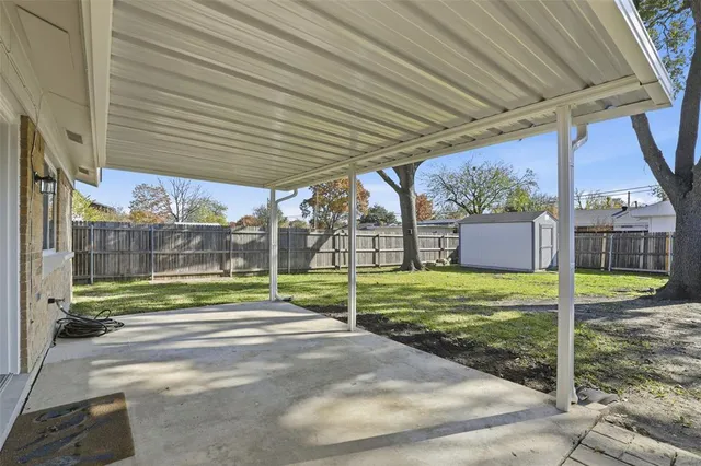 a view of a porch with furniture and garden