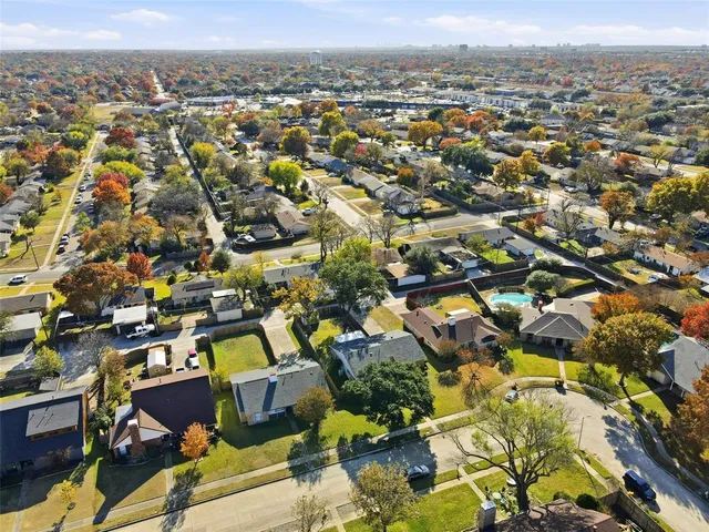 an aerial view of residential houses with city view