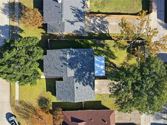 aerial view of a house with a yard