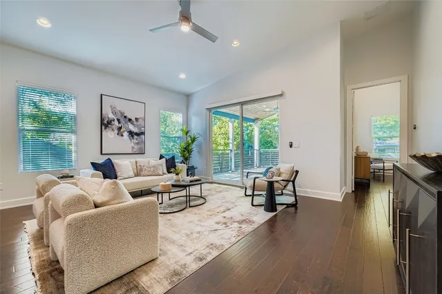 a living room with furniture kitchen view and a table