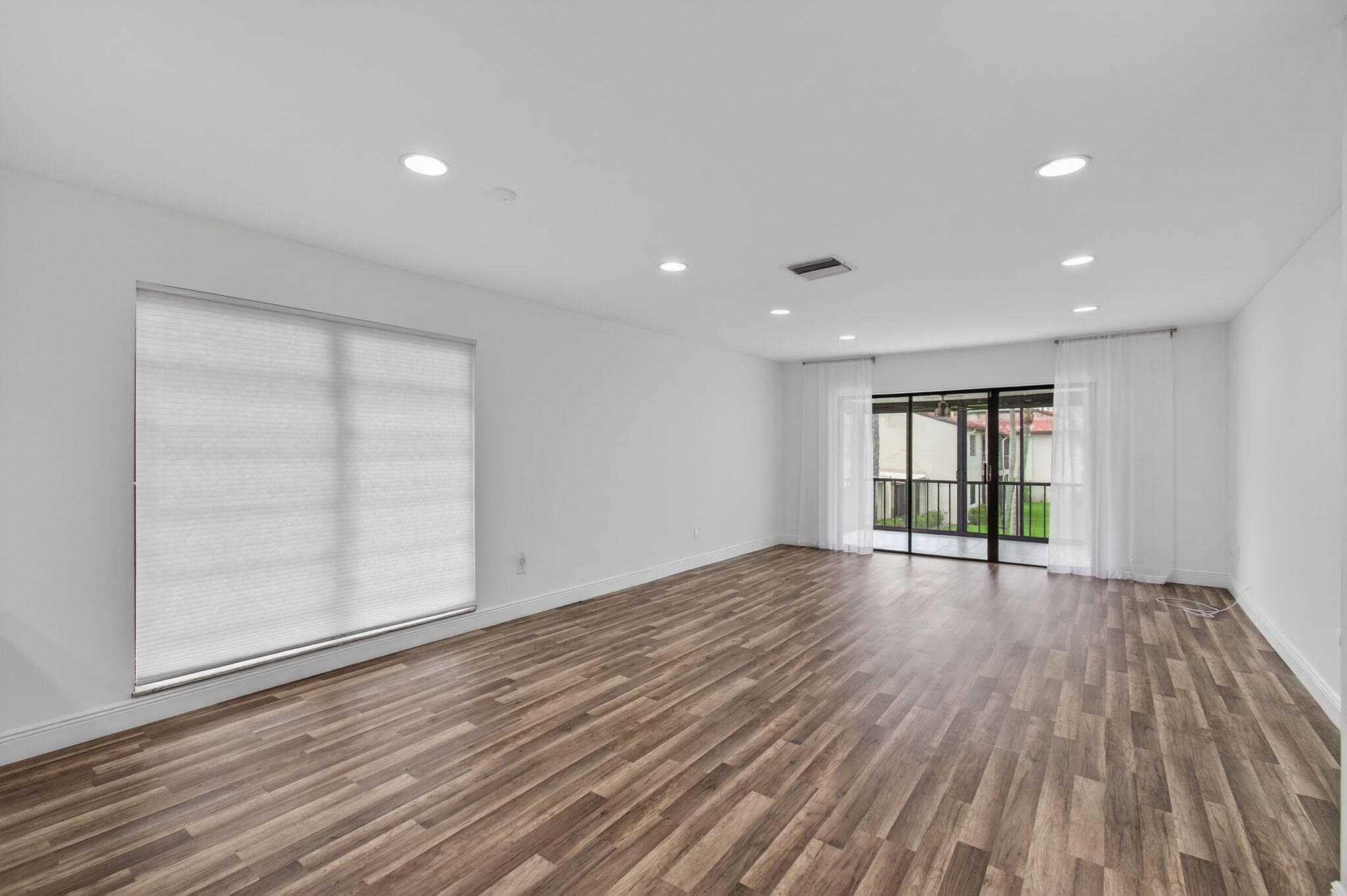 8536 Casa Del Lago, Unit 49B Boca Raton, FL 33433 - Photo 9 of 79 wooden floor in an empty room with a window